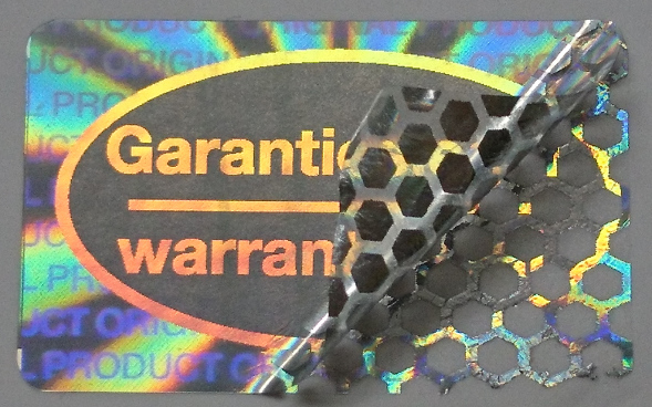 Garantiesiegel aus Hologrammfolie - Wabenmuster gegen unerlaubte Ablöseversuche Garantiesiegel - warranty seal aus manipulationssicherer Hologrammfolie mit Wabenmuster-Zerstör-Effekt bei Ablöseversuchen
